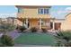 Spacious backyard with covered patio, artificial turf, and mature plants at 772 Crimson Peak Pl, Henderson, NV 89011