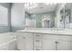 Bathroom boasts double sinks, a large mirror, and a bathtub at 772 Crimson Peak Pl, Henderson, NV 89011