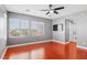 Bright bedroom featuring wood floors, ceiling fan, and ensuite bathroom at 772 Crimson Peak Pl, Henderson, NV 89011