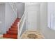 Bright entryway with wood staircase and tiled flooring at 772 Crimson Peak Pl, Henderson, NV 89011