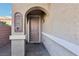 Front entry with arched entryway and decorative wall art at 772 Crimson Peak Pl, Henderson, NV 89011