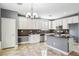 Eat-in kitchen with white cabinets and granite countertops at 772 Crimson Peak Pl, Henderson, NV 89011