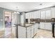 Bright kitchen with granite countertops, white cabinets and sliding glass door at 772 Crimson Peak Pl, Henderson, NV 89011