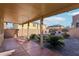 Covered patio with view of backyard landscaping and fountain at 772 Crimson Peak Pl, Henderson, NV 89011