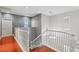 Upstairs hallway with hardwood floors and white railings at 772 Crimson Peak Pl, Henderson, NV 89011