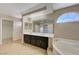 Bathroom features a double vanity and a large soaking tub at 7978 Coronado Coast St, Las Vegas, NV 89139