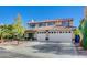 Two-story house with a three-car garage and a landscaped front yard, featuring a pool at 7978 Coronado Coast St, Las Vegas, NV 89139