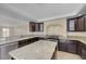 Modern kitchen with granite countertops and dark wood cabinets at 7978 Coronado Coast St, Las Vegas, NV 89139