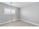 Simple bedroom with grey walls and wood-look flooring at 8016 Roundup Ridge St, Las Vegas, NV 89131