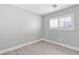 Simple bedroom with grey walls and wood-look flooring at 8016 Roundup Ridge St, Las Vegas, NV 89131