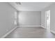 Bright bedroom featuring grey walls and wood-look flooring at 8016 Roundup Ridge St, Las Vegas, NV 89131