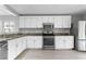 Kitchen with white cabinets, granite countertops, and stainless steel appliances at 8016 Roundup Ridge St, Las Vegas, NV 89131