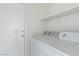 Laundry room with washer, dryer, and shelving at 8016 Roundup Ridge St, Las Vegas, NV 89131