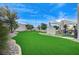 Landscaped backyard with putting green, pergola, and artificial turf at 8104 Via Del Cerro Ct, Las Vegas, NV 89117