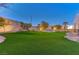 Spacious backyard with artificial turf and landscape lighting at 8104 Via Del Cerro Ct, Las Vegas, NV 89117