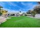 Expansive backyard with artificial turf and a covered patio at 8104 Via Del Cerro Ct, Las Vegas, NV 89117