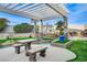 Relaxing backyard patio with pergola, seating area, and artificial turf at 8104 Via Del Cerro Ct, Las Vegas, NV 89117