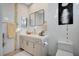 Modern bathroom with light wood vanity, mosaic accents, and a frameless glass shower at 8104 Via Del Cerro Ct, Las Vegas, NV 89117