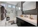 Modern bathroom with a walk-in shower, dark vanity, and white tile at 8104 Via Del Cerro Ct, Las Vegas, NV 89117