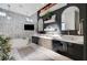 Elegant bathroom with double vanities, soaking tub, and marble tile at 8104 Via Del Cerro Ct, Las Vegas, NV 89117