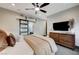 Serene bedroom with a cozy bed, dresser, and sliding barn door at 8104 Via Del Cerro Ct, Las Vegas, NV 89117