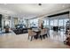 Open concept dining room with modern chandelier and seating for eight at 8104 Via Del Cerro Ct, Las Vegas, NV 89117