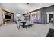 Elegant dining room with modern light fixture and seating for eight at 8104 Via Del Cerro Ct, Las Vegas, NV 89117