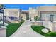 Modern home exterior with paved pathway, water feature, and lush landscaping at 8104 Via Del Cerro Ct, Las Vegas, NV 89117