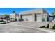 Three-car garage with modern glass doors and a long driveway at 8104 Via Del Cerro Ct, Las Vegas, NV 89117