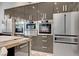 Modern kitchen with stainless steel appliances and sleek gray cabinetry at 8104 Via Del Cerro Ct, Las Vegas, NV 89117