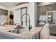 Kitchen island with waterfall edge, sink, and built-in wine cooler at 8104 Via Del Cerro Ct, Las Vegas, NV 89117