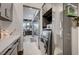 Bright laundry room with washer, dryer, and built-in cabinetry at 8104 Via Del Cerro Ct, Las Vegas, NV 89117