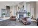 Elegant living area with a fireplace and leather armchairs at 8104 Via Del Cerro Ct, Las Vegas, NV 89117