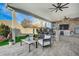 Outdoor kitchen with stone finishes and seating area at 8104 Via Del Cerro Ct, Las Vegas, NV 89117