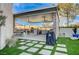 Outdoor kitchen with grill and seating area near the lawn at 8104 Via Del Cerro Ct, Las Vegas, NV 89117