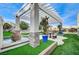 Landscaped backyard with pergola, fountain, and seating at 8104 Via Del Cerro Ct, Las Vegas, NV 89117