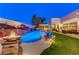 Expansive pool and patio with fire pit and waterfall at 8104 Via Del Cerro Ct, Las Vegas, NV 89117