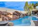 Inviting pool with a waterfall feature and large rocks at 8104 Via Del Cerro Ct, Las Vegas, NV 89117