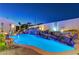 Luxury pool with waterfall feature and night lighting at 8104 Via Del Cerro Ct, Las Vegas, NV 89117