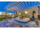 Night view of a tranquil pool and spa area with a pergola at 8104 Via Del Cerro Ct, Las Vegas, NV 89117