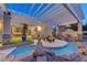 Night view of a tranquil pool and spa area with a pergola at 8104 Via Del Cerro Ct, Las Vegas, NV 89117