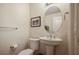 Clean bathroom with pedestal sink, toilet, and oval mirror at 8255 Las Vegas Blvd # 619, Las Vegas, NV 89123