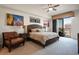 Spacious bedroom with a king-size bed, a chair, and access to balcony at 8255 Las Vegas Blvd # 619, Las Vegas, NV 89123