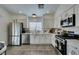 Modern kitchen with white cabinets, stainless steel appliances, and quartz countertops at 8634 Lakota St, Las Vegas, NV 89123