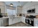 Modern kitchen with white cabinets, stainless steel appliances, and quartz countertops at 8634 Lakota St, Las Vegas, NV 89123