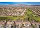 Aerial view of community near golf course and mountains at 9016 Sundial Dr, Las Vegas, NV 89134