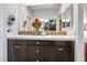 Double vanity bathroom with modern dark cabinets and a large mirror at 9016 Sundial Dr, Las Vegas, NV 89134