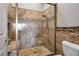 Large walk-in shower with neutral tile and pebble floor at 9016 Sundial Dr, Las Vegas, NV 89134