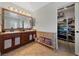 Elegant bathroom with double sinks, large mirror, and walk-in closet at 9048 Rich Amethyst Ct, Las Vegas, NV 89149