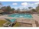 Inviting community swimming pool with lounge chairs at 9048 Rich Amethyst Ct, Las Vegas, NV 89149